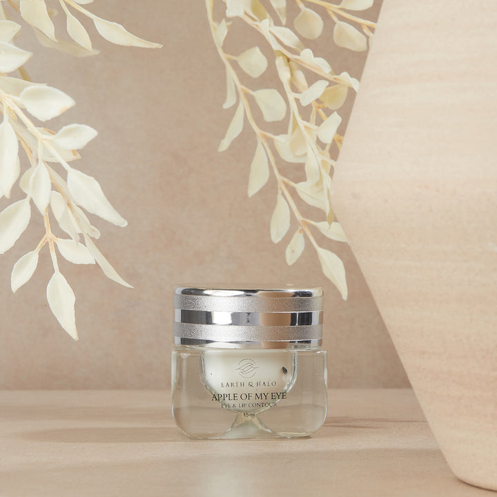 Earth & Halo Apple Of My Eye Eye & Lip Contour 15 ml jar on a beige pedestal